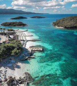 an aerial view of a beach with blue water at Vila Balani in Ksamil