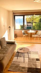 a living room with a couch and a table at Apartment Kaltenbrunn Serviced Apt mit Seeblick am Tegernsee Business & Long Stay only in Gmund am Tegernsee