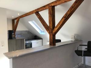 a kitchen with a counter with wooden beams at Apartment Hildesheim in Hildesheim