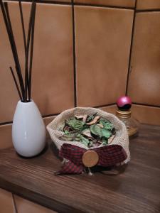 a bowl of food sitting on a table next to a vase at Apartament Rita in Godziszka