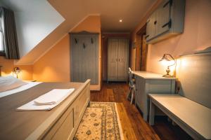 a room with a bed and a desk and a kitchen at Hotel Zamorc in Škofja Loka