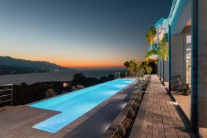 a swimming pool with a view of the ocean at Heaven's Door Samos in Samos