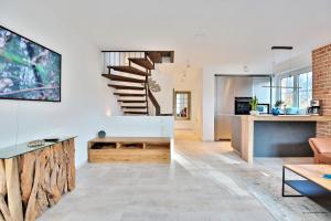 a living room with a staircase and a couch at Haus Oberdeck 1 in Scharbeutz