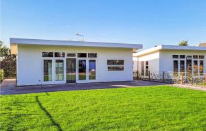 a large white house with a grass yard at Schiermonnikoog in Den Oever