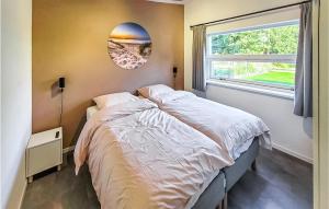 a bedroom with a large bed and a window at Schiermonnikoog in Den Oever