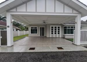 a large white house with a large patio at Batu Pahat Karaoke LawnView TvBox BBQ Villa in Batu Pahat