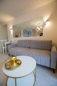 a living room with a couch and a table at Apartament in Bochnia