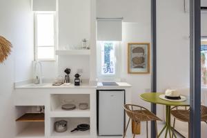 a small kitchen with a small table and a counter at Isla apartment's in Tel Aviv