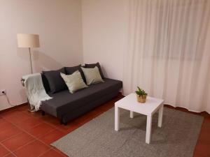 a living room with a couch and a table at Casa da Dina in Ponte de Lima