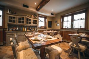 a dining room with a wooden table and chairs at Hotel Zamorc in Škofja Loka