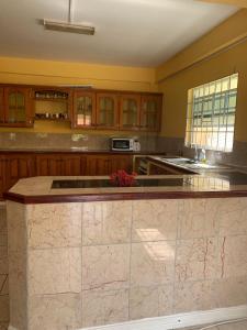 a large kitchen with a marble counter top at Cummin up in Fort Jeudy