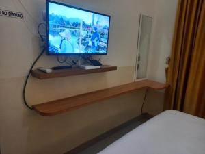 a tv sitting on a shelf in a room at Villa Bandungan, Semarang in Bandungan