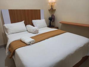 מיטה או מיטות בחדר ב-Villa Bandungan, Semarang