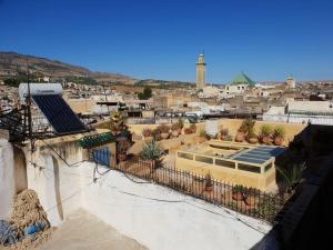 a view of a city from a building with plants at House in the old Medina of Fez in Fès al Bali