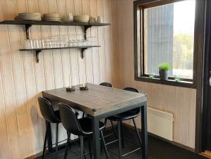 a table and chairs in a room with a window at 5 beds Cabin in Tänndalen, Funäsdalen in Tänndalen