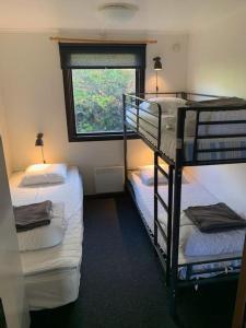 a room with two bunk beds and a window at 5 beds Cabin in Tänndalen, Funäsdalen in Tänndalen