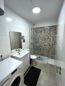 y baño con lavabo y lavadora. en Sunny Halley apartament en El Médano