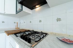 a kitchen with a stove top oven in a kitchen at Torre di Amalfi - holiday house in Amalfi