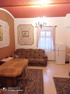 a living room with a couch and a table at Atlantis Apartmán 2 in Klášterec nad Ohří +27 photos