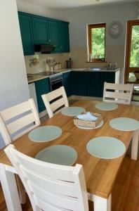a kitchen with a wooden table with chairs around it at Beautiful Riverside Retreat in Blackwater, Wexford in Blackwater