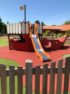 a playground with a slide in a park at MOBIL HOME Tendance Tout Confort - FUNPASS non included in Gastes