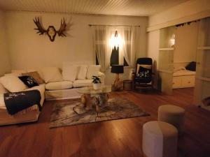 a living room with a couch and a table at Villa Tiiro in Ii