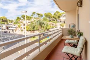 a balcony with a table and chairs and a view of a street at Casa Marina Moraira in Moraira