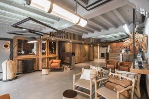 a living room with wooden walls and chairs at Riu Nere Mountain Hotel in Vielha