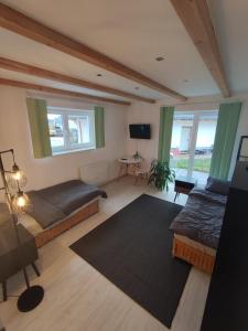 a room with two beds and a table and windows at Bungalow mit 200 qm Wohnfläche :) in Birgland