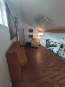 a living room with a staircase and a chair and a table at Bungalow mit 200 qm Wohnfläche :) in Birgland