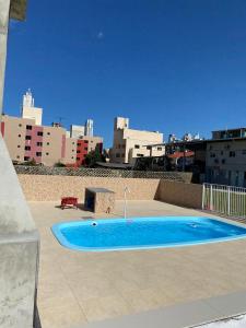 a blue swimming pool on the roof of a building at Loft e Suites Temporada in Balneário Camboriú +28 photos