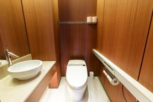 a bathroom with a white toilet and a sink at スタンザベルデ名古屋 in Nagoya