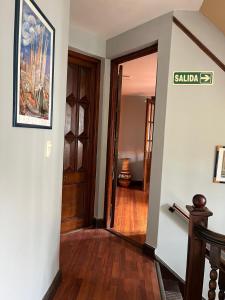 a hallway of a home with a door and wooden floors at Hotel Boutique Calash in Mar del Plata