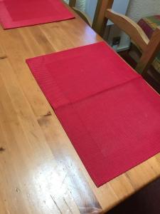 a wooden table with red napkins on top of it at appartement ski au pied in Valmorel +3 photos