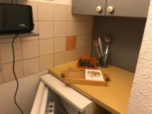 a kitchen counter with a cutting board on top of it at appartement ski au pied 