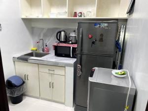 a small kitchen with a refrigerator and a sink at 4 - Affordable 2-Storey House in Cabanatuan City in Cabanatuan