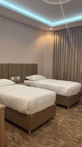 Ένα ή περισσότερα κρεβάτια σε δωμάτιο στο قمم بارك 3 Qimam Park Hotel