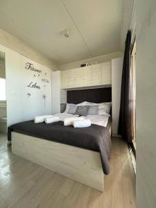a bedroom with a large bed in a room at Hollers Holiday Homes Haus Oli in Drage