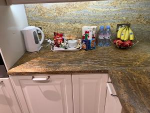 a kitchen counter with food and drinks on it at TJ Homes - Entire place for 5 Guests - London in Ruislip