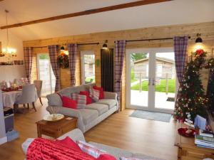 a living room with a christmas tree in it at Stags Barn Saxon Maybank in Sherborne