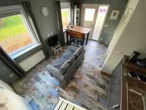 a living room with a couch and a table at Appartement - B&B de Koog in Uitgeest