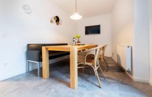 a dining room with a wooden table and chairs at Stay and Work Apartment - 6 single beds in Bocholt