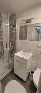 a bathroom with a sink and a shower and a toilet at Apartament Eden Chopina in Karpacz