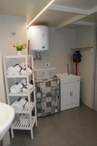 baño con lavabo y estante con toallas en House SantaFè2, en Catania