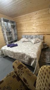 a bedroom with two beds and two chairs at Sadyba Dana in Tatariv