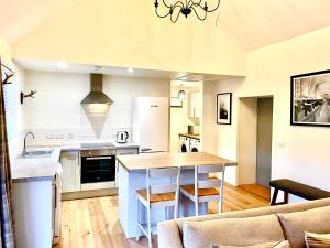 a kitchen with a large island in a living room at The Old Croft in Fort Augustus