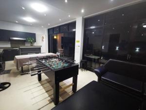 a living room with a table with a chess board on it at Lovely 2-bedroom hotspring resort in Calamba