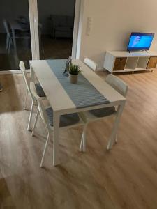 a white table and chairs with a laptop on it at Ferienwohnung Westerwald-Domizil 