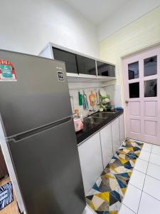 サンダカンにあるKW HOMESTAY CASA UNO APARTMENTのキッチン(ステンレス製の冷蔵庫、シンク付)