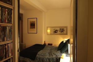a bedroom with a bed and a book shelf at Serbie 21 in Brussels